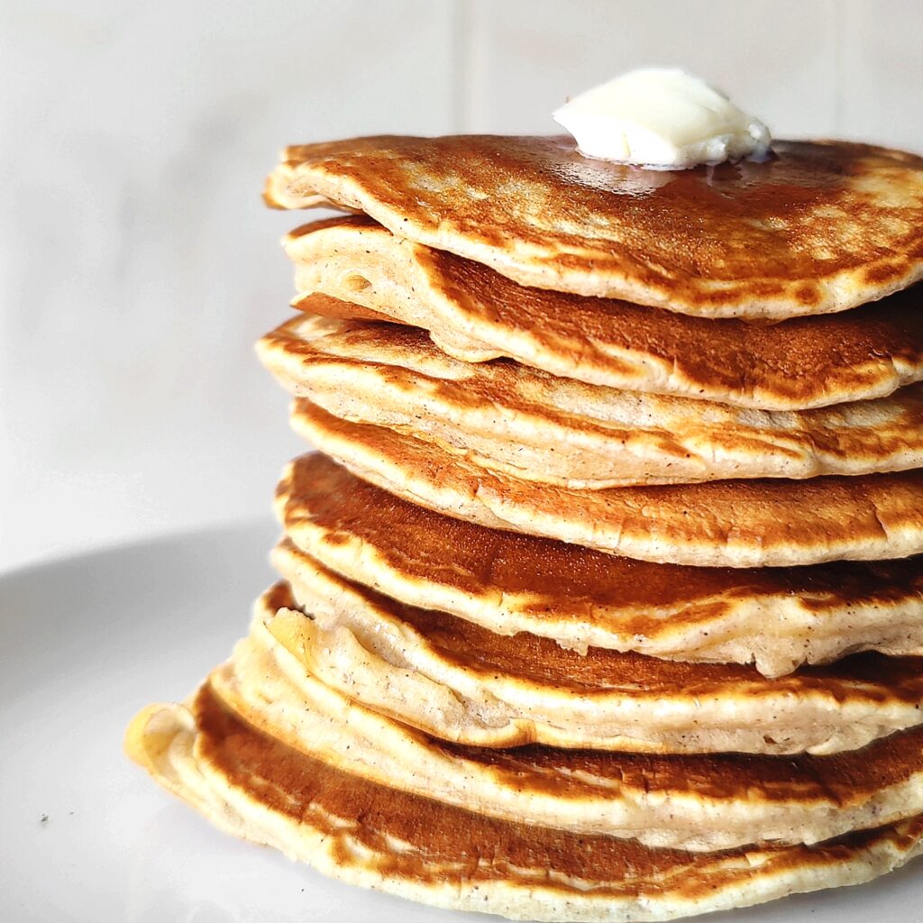 stack of pancakes with butter on top